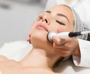 Beautiful woman in professional beauty salon during photo rejuve